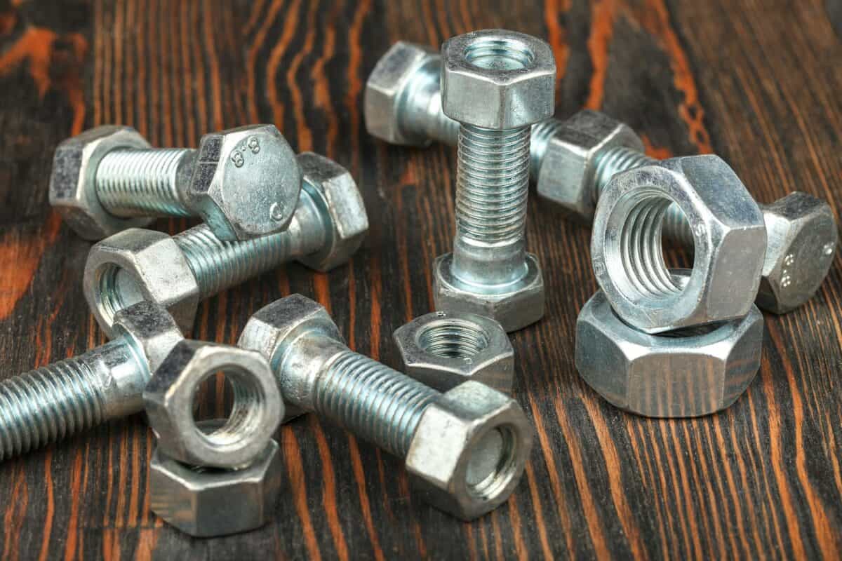 Bolts and nuts on a wooden surface
