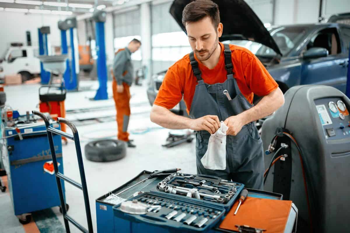 Car mechanic keeping tools polished