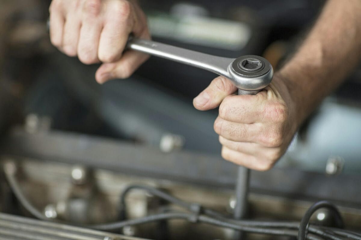 Close-up of hands using a socket wrench