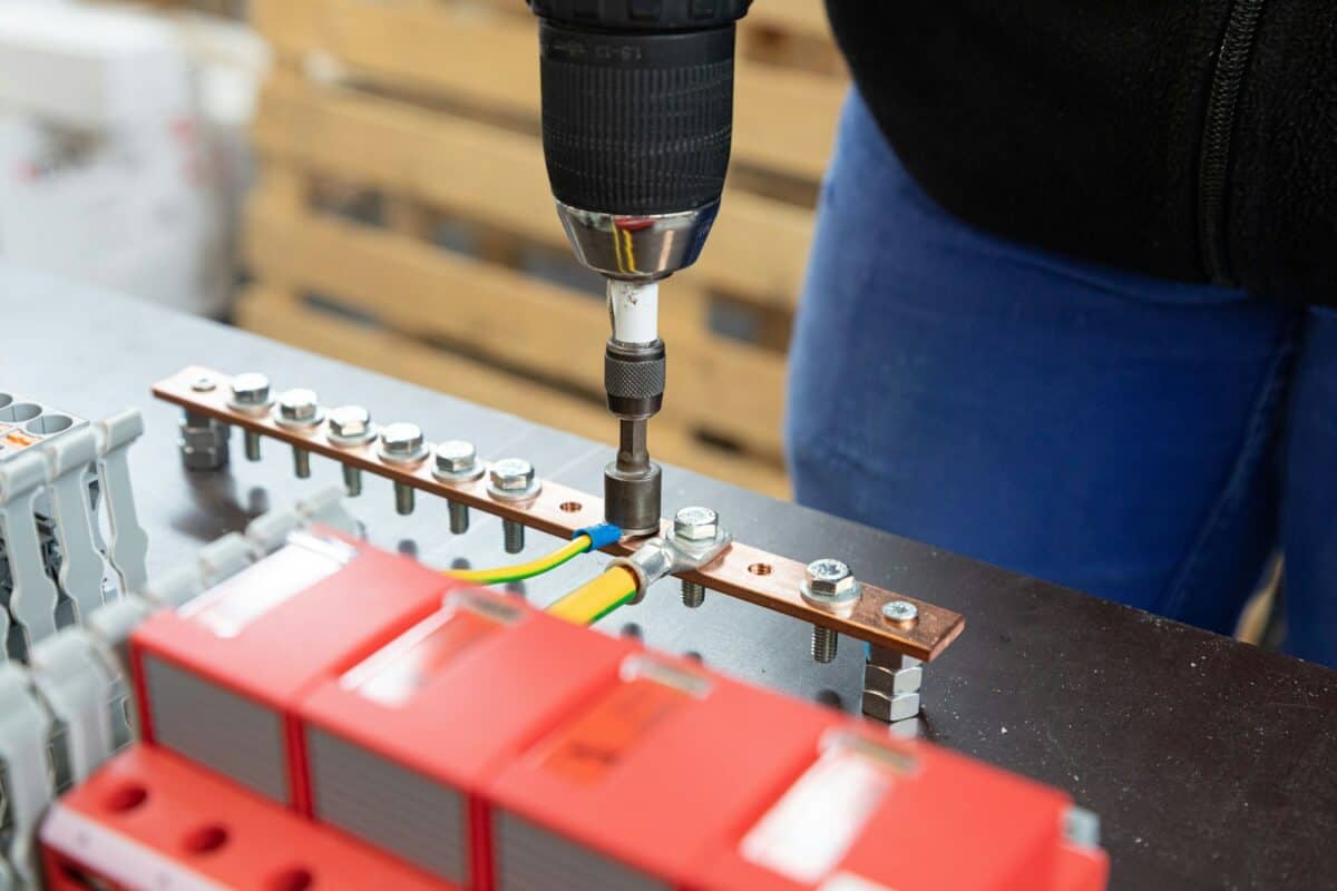 Closeup of a screwdriver screwing a nut