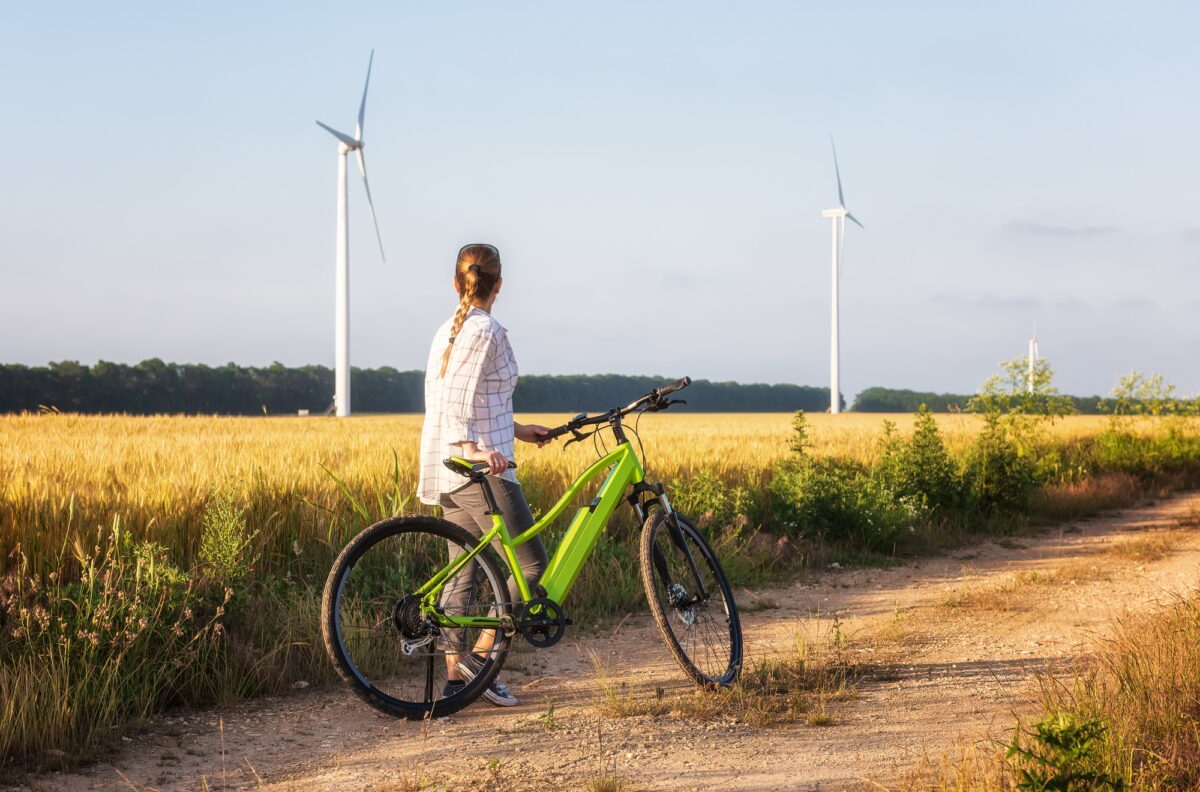 Woman with a bike in the nature