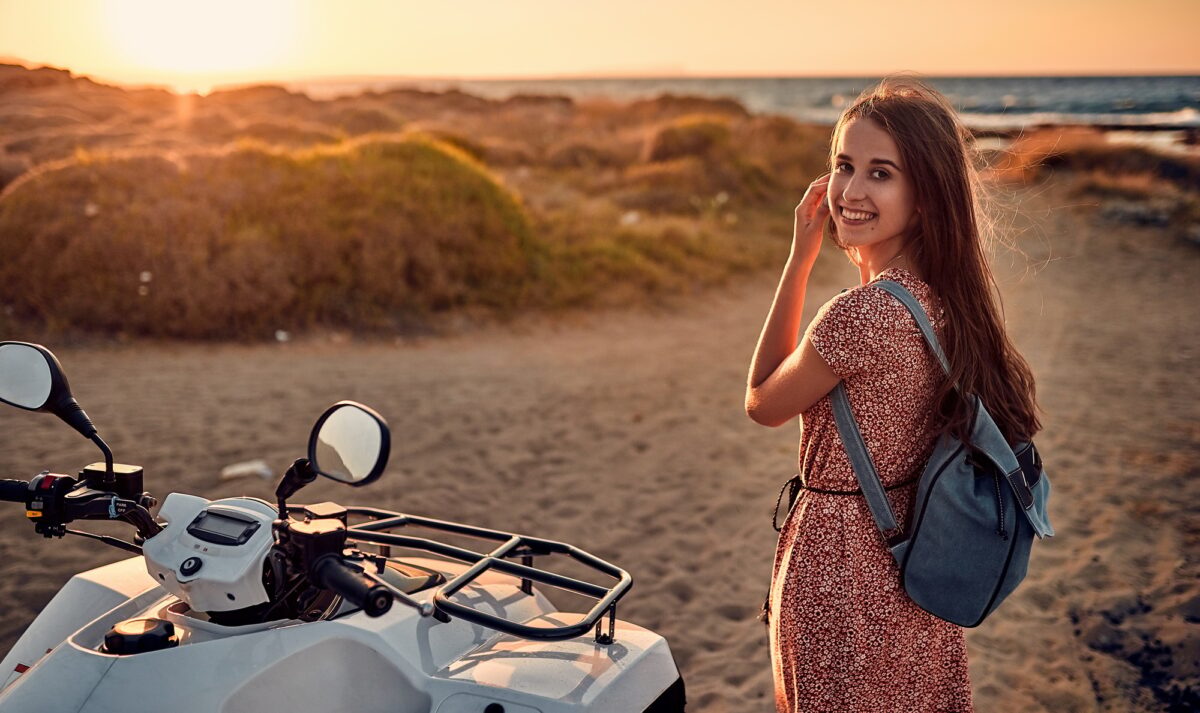 Girl with quad bike on the beach
