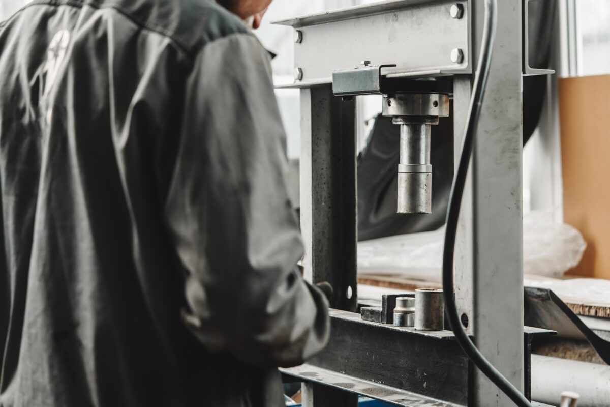 Close up of automechanic changing the silent block in the hydraulic press in the car service