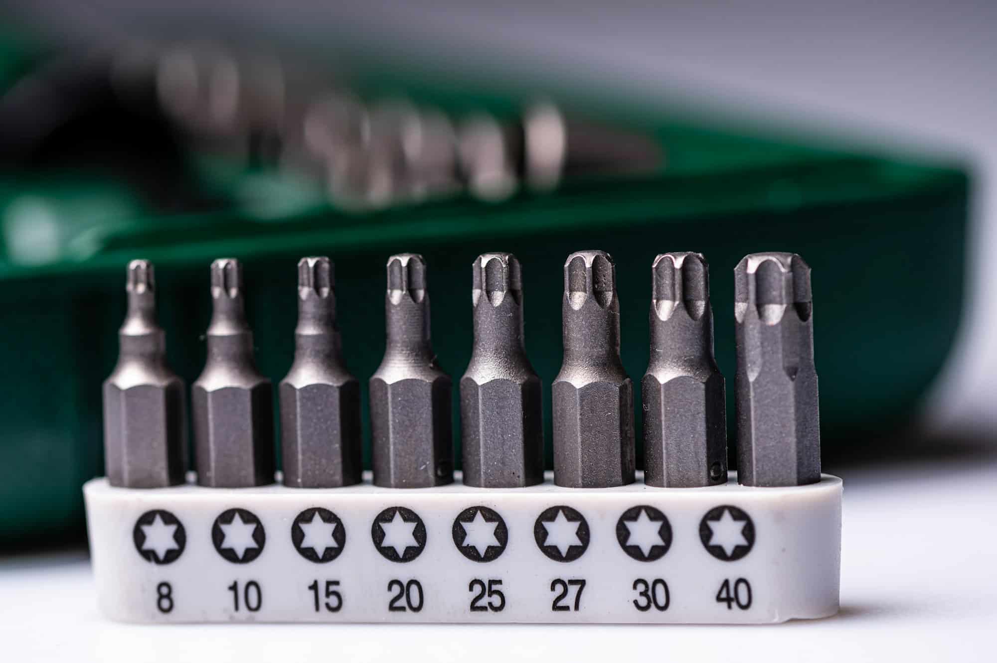 Interchangeable screwdriver bit set, isolated on white, selective focus, dof, closeup