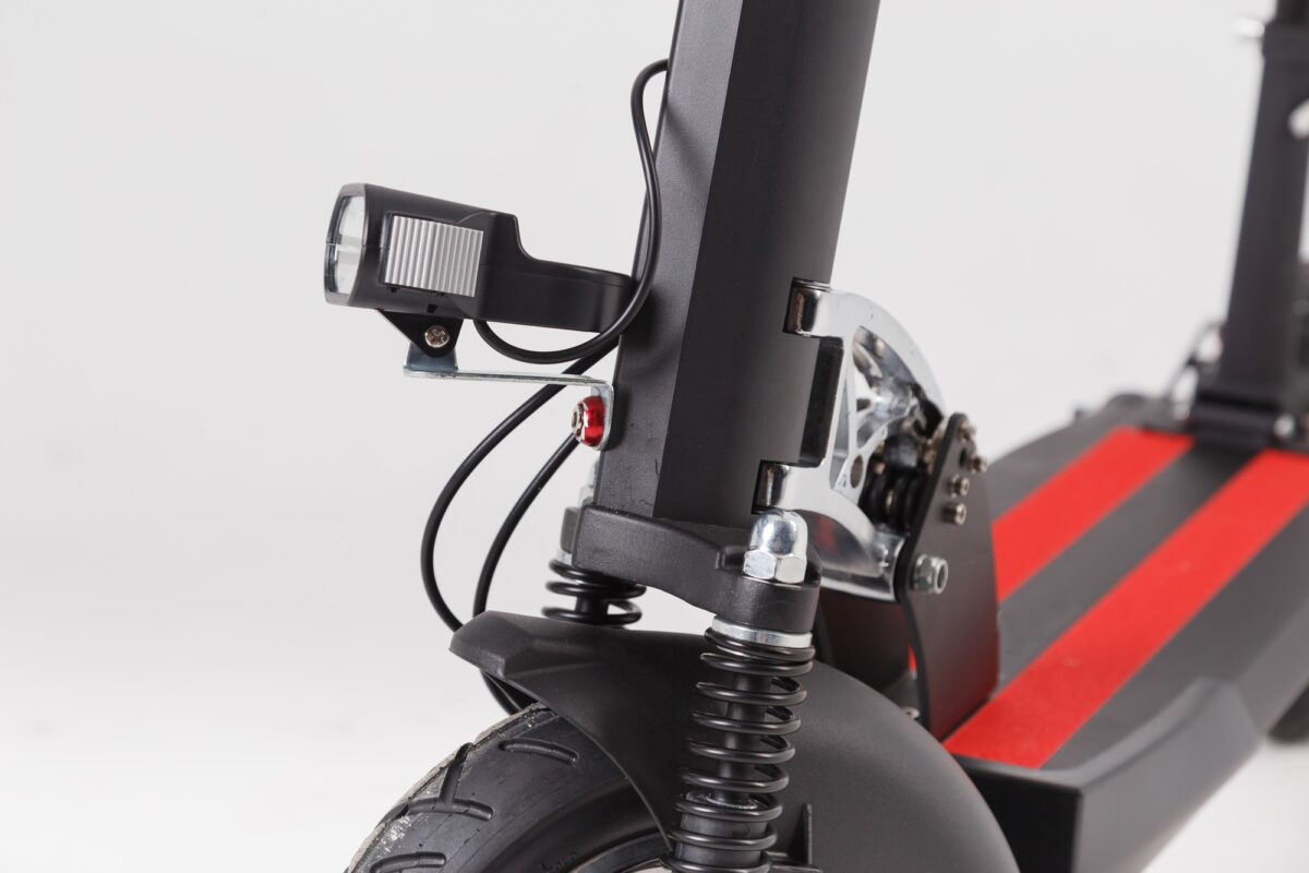 Flashlight and shock absorber on a close-up of the electric scooter