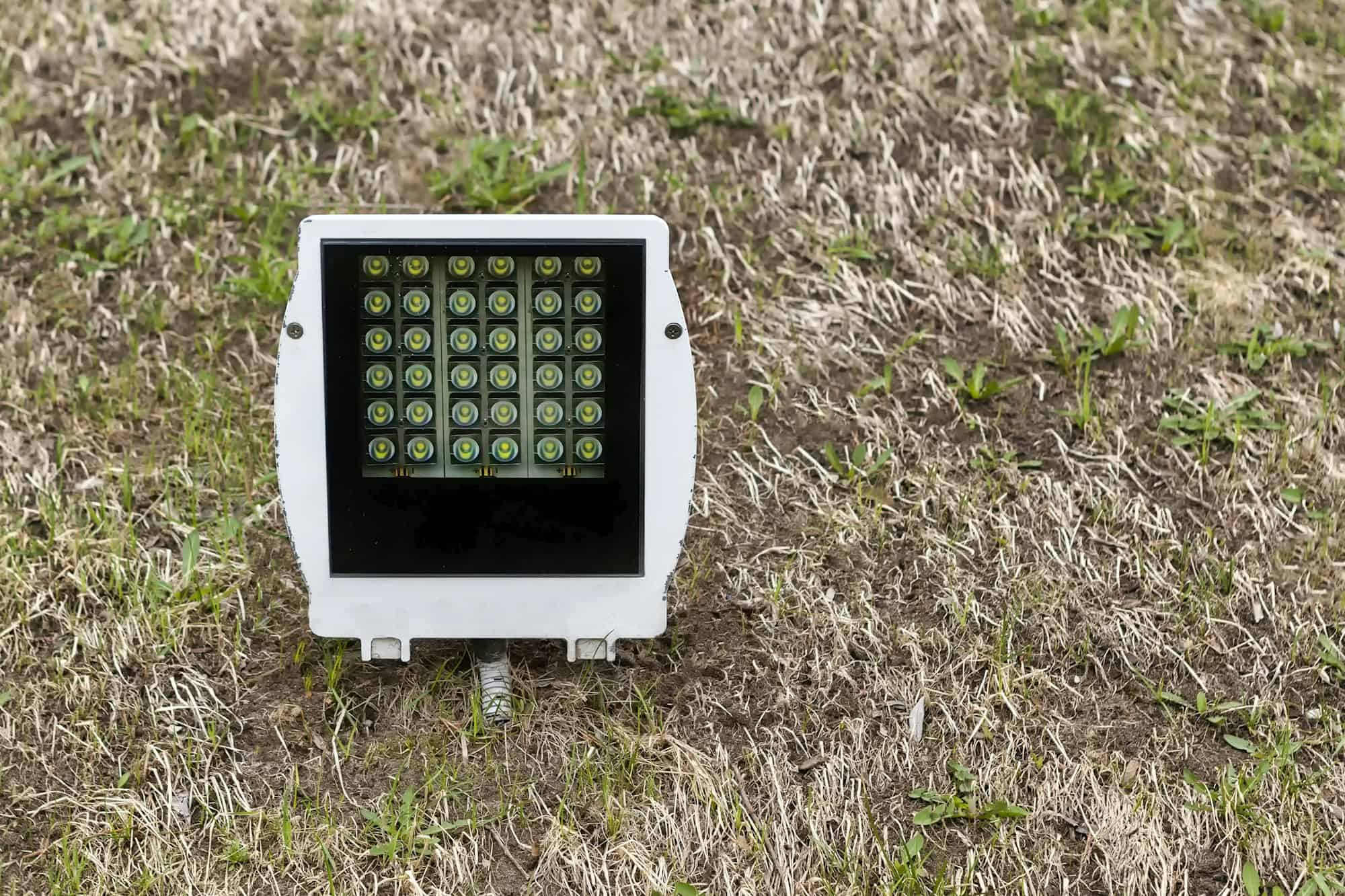 Led spotlight on the lawn. Day, horizontal shot front view.