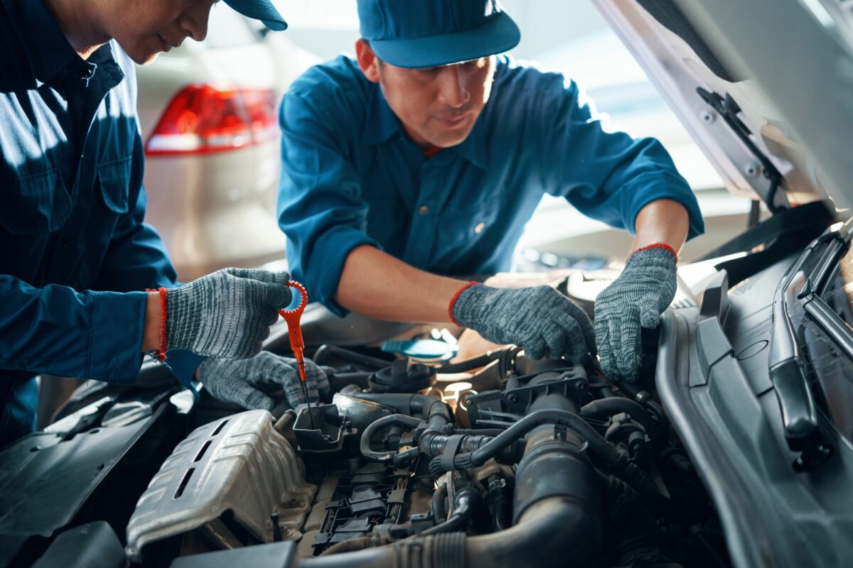 Mechanics checking car motor