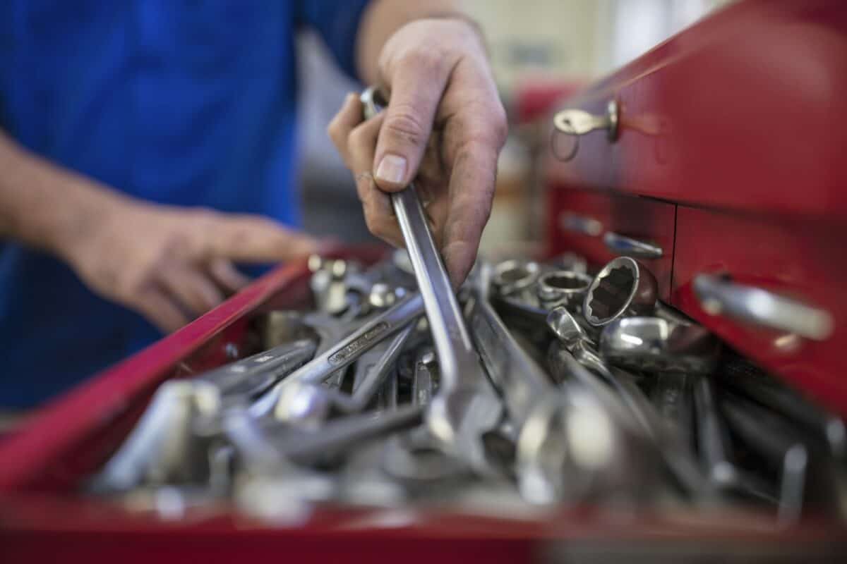Mechanic selecting a tool from a toolbox.