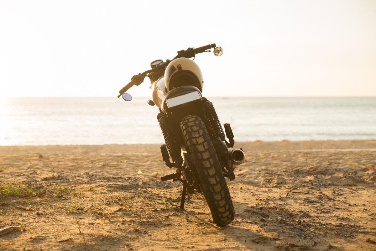 Female biker driving a cafe' racer motorbike