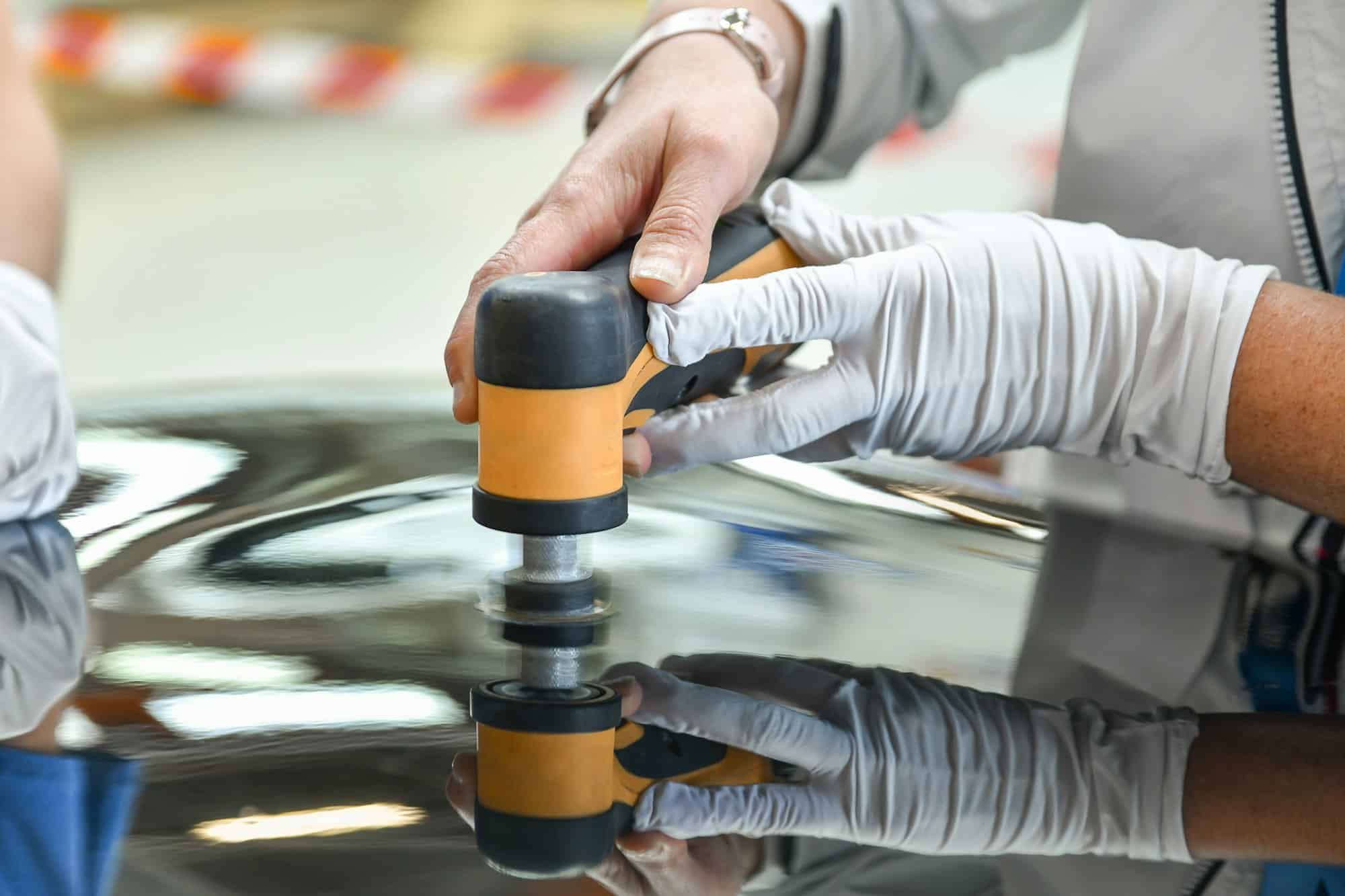 Operator holds a polisher in the hand for scratch