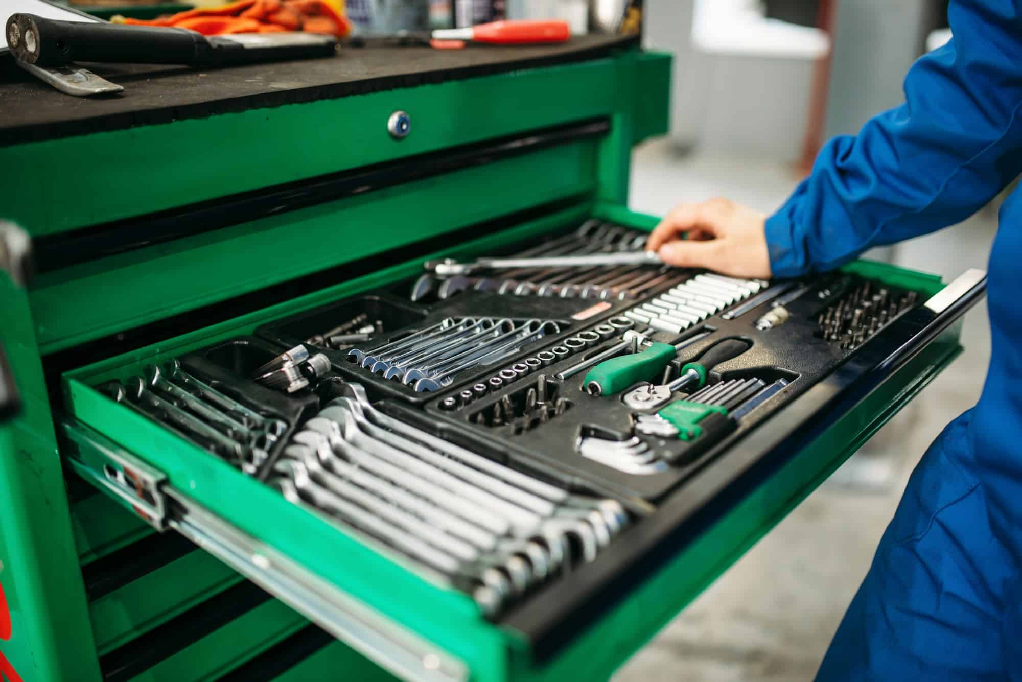 Repairman hand reaching for the tool box