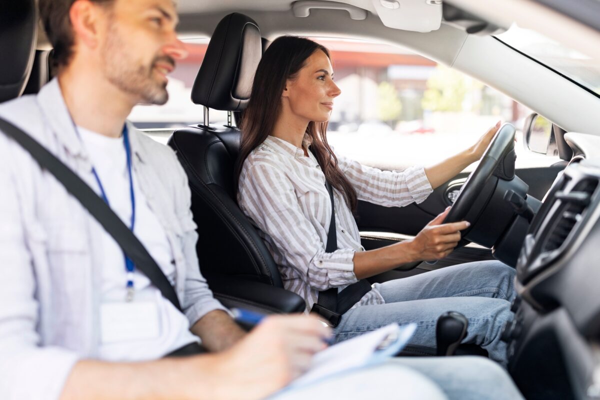 Confident young lady passing exams at driving school